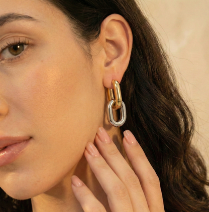 Close-up of a woman wearing a gold and silver hoop earring.