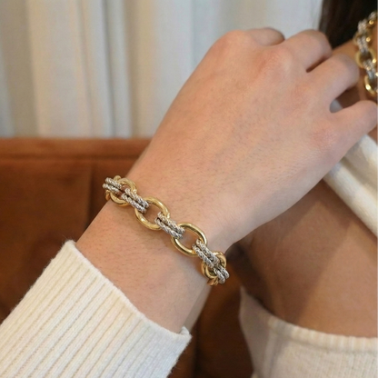 Gold bracelet on a wrist with a blurred background