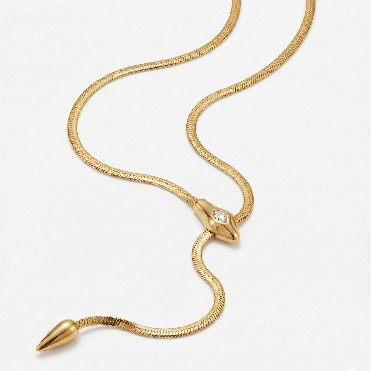 Gold snake-shaped necklace on a white background