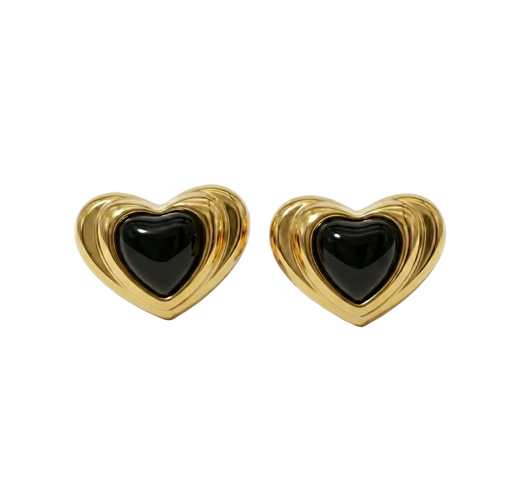 Heart-shaped earrings with gold border and black center on a white background
