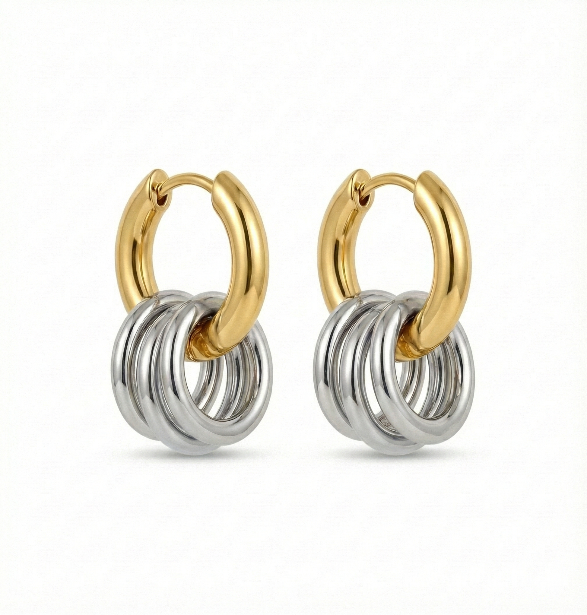 Pair of gold and silver hoop earrings on a white background