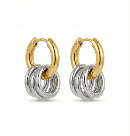 Pair of gold and silver hoop earrings on a white background