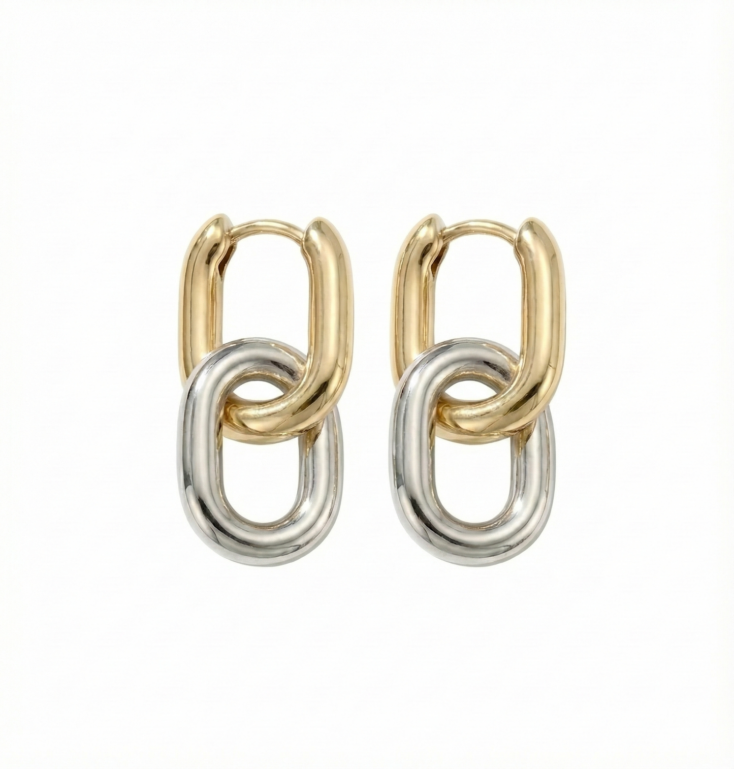 Pair of gold and silver hoop earrings on a white background