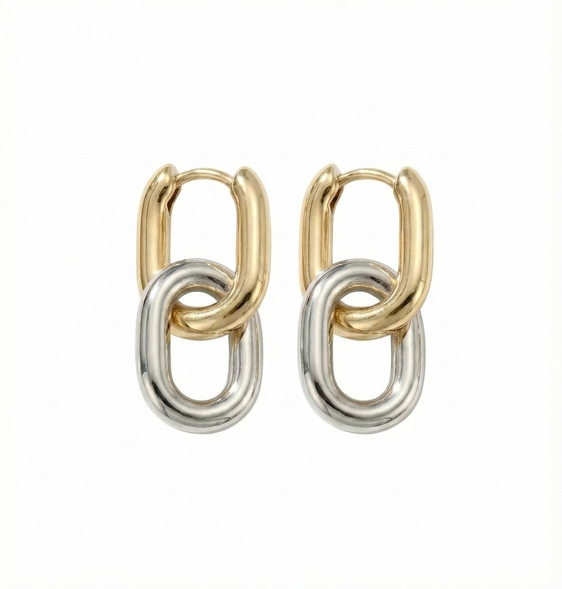 Pair of gold and silver hoop earrings on a white background