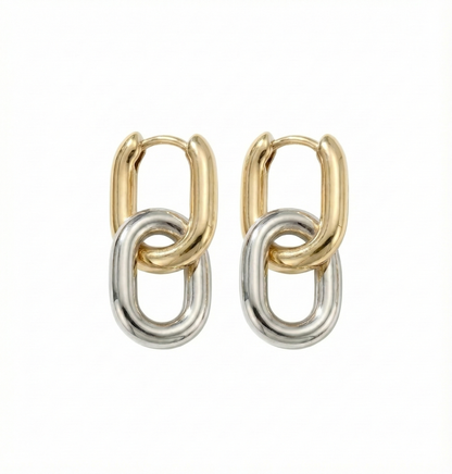 Pair of gold and silver hoop earrings on a white background