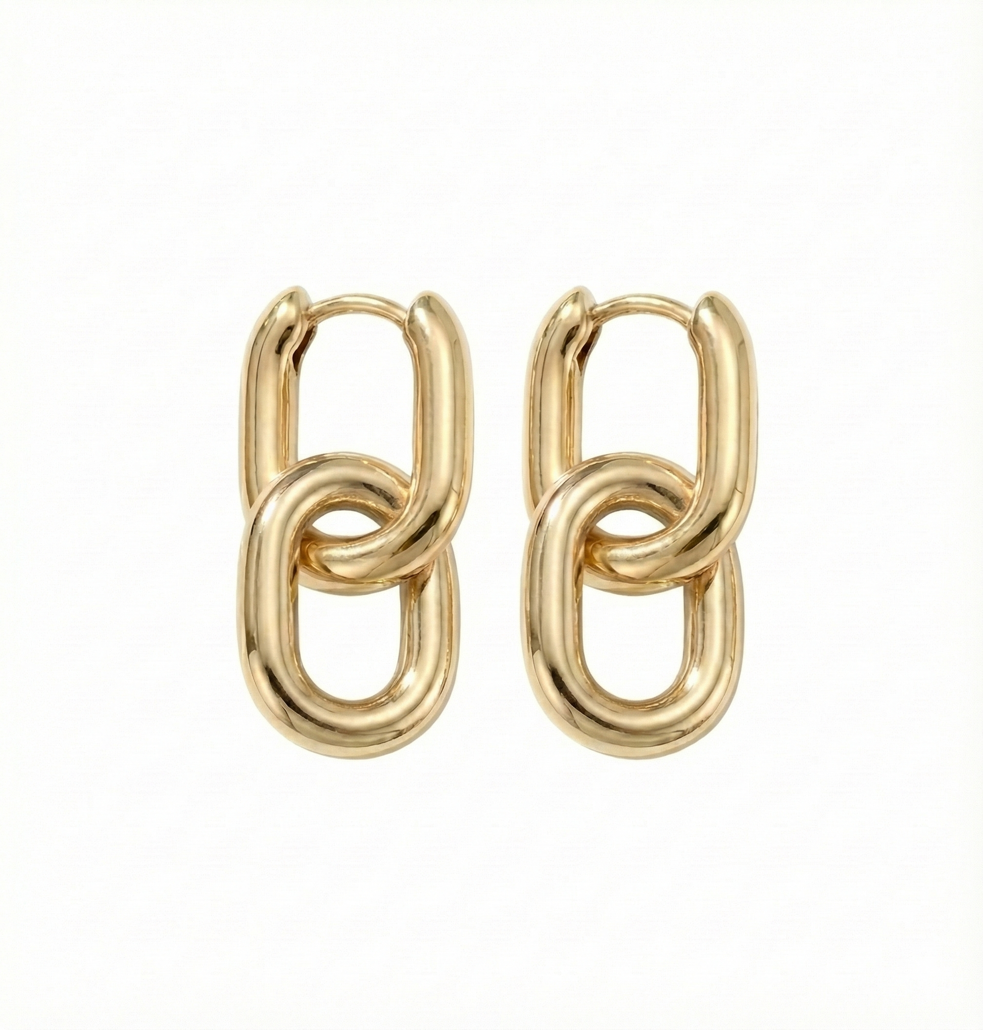 Pair of gold chain link earrings on a white background