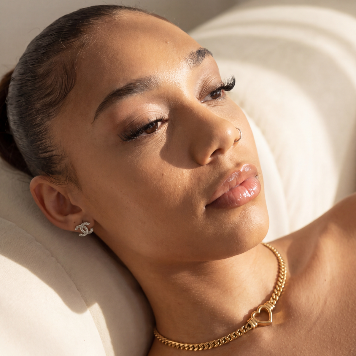 Woman lying on a white cushion with soft lighting
