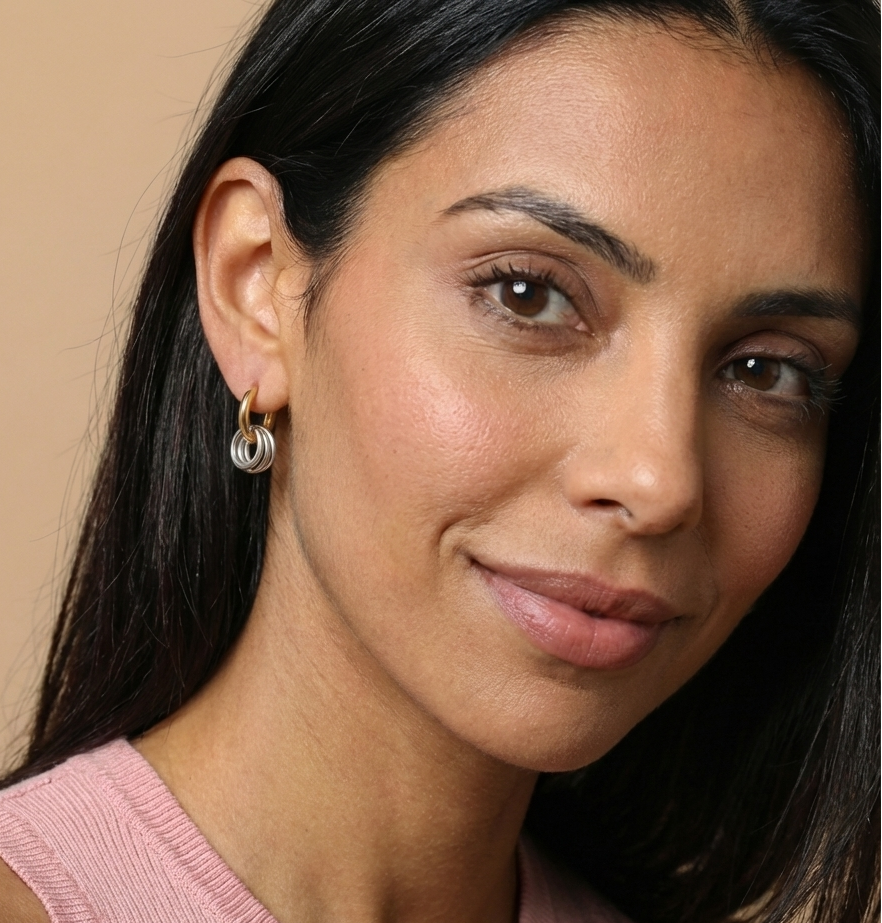 Woman wearing a pink sleeveless top against a beige background