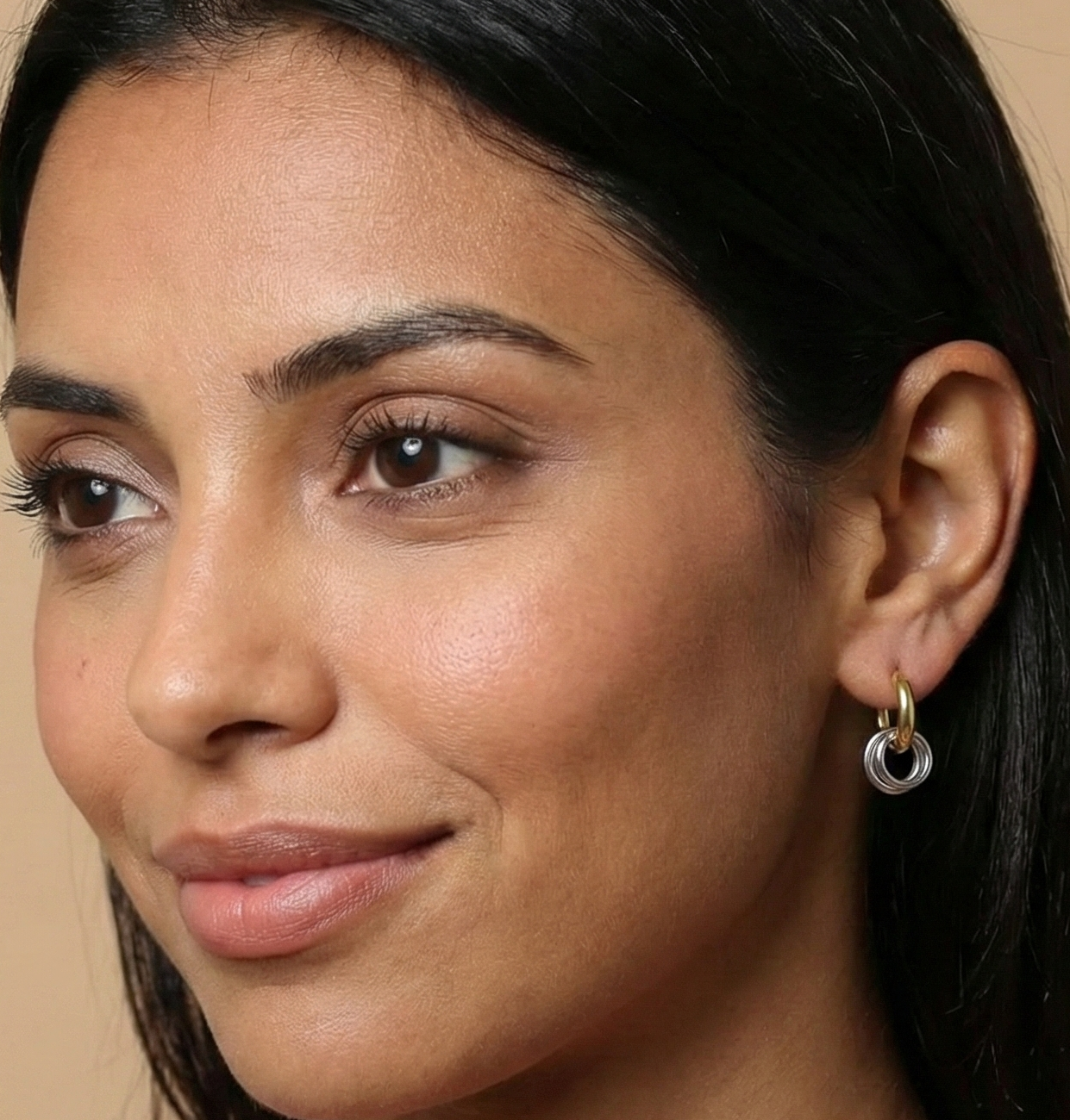 Woman wearing a pink sleeveless top against a beige background