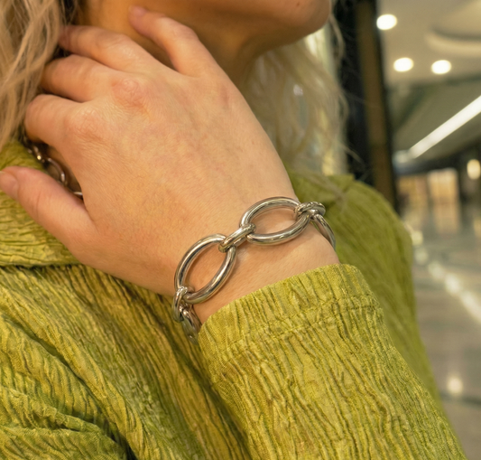 bracelet in front of green shirt